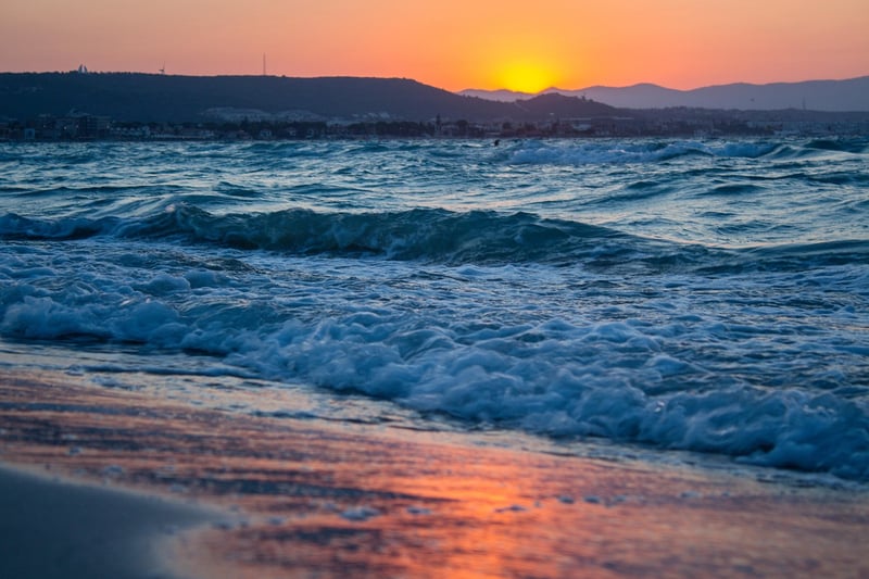 Woman Walking on Beach at Sunset